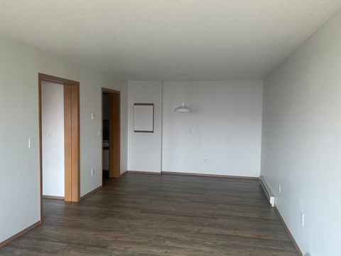 A room with wooden floors and white walls.