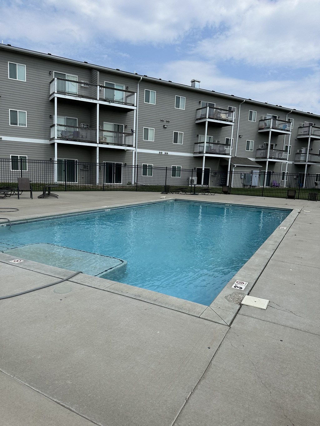 a swimming pool in front of an apartment building