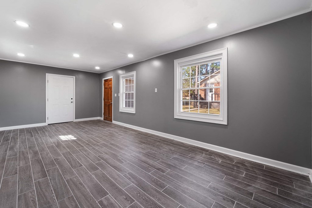 a empty room with a window and a door