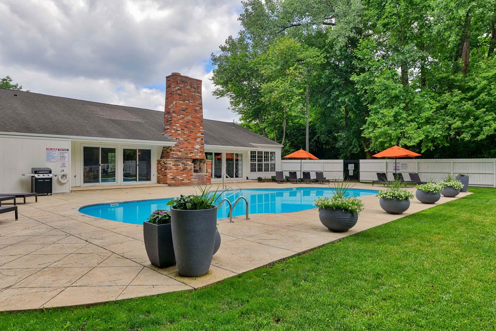 a backyard with a swimming pool and a house