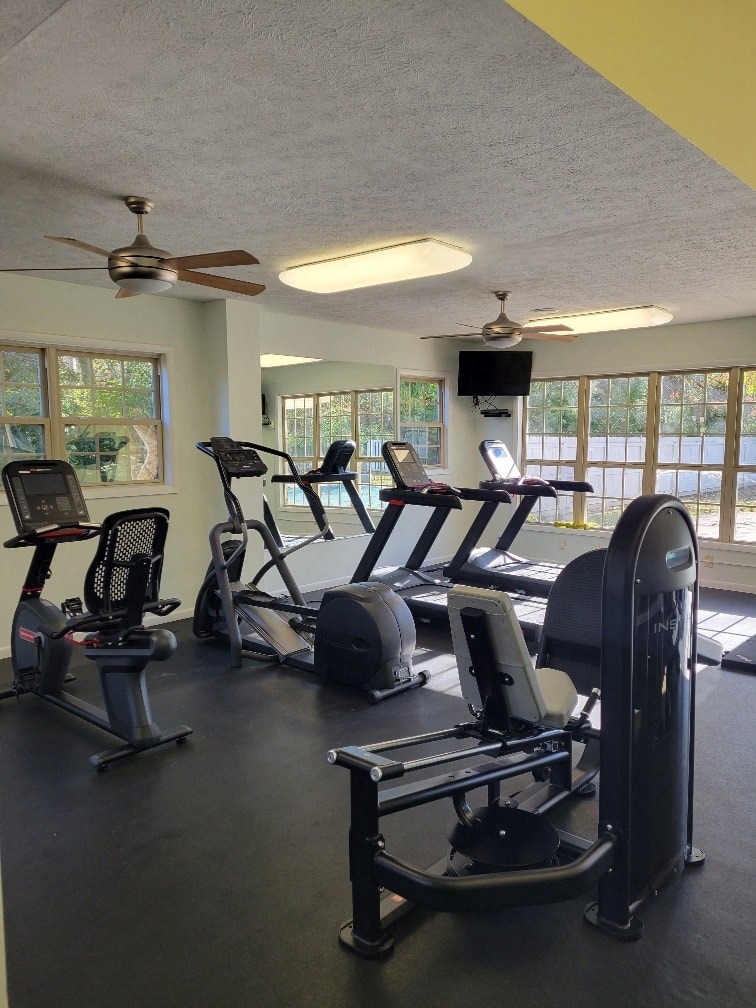 a gym with a lot of exercise equipment in it