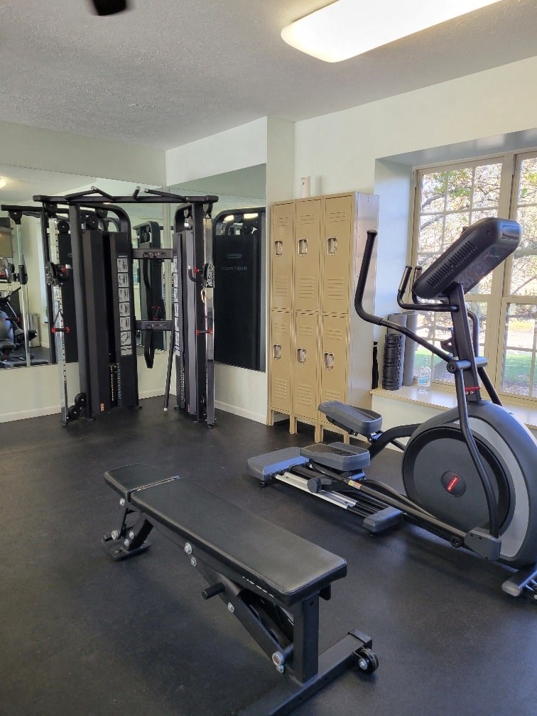 the gym has a lot of equipment in it