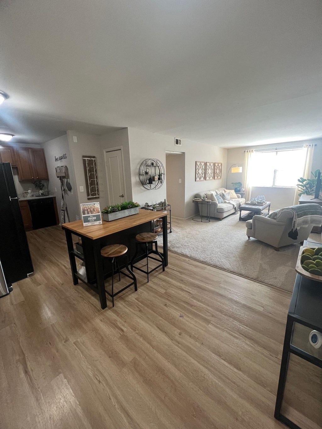 a view of a living room and dining room from the kitchen