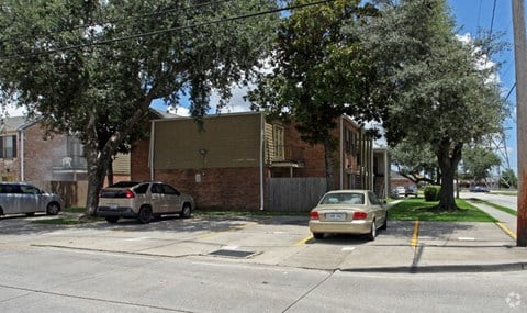 a street with cars parked in front of a building