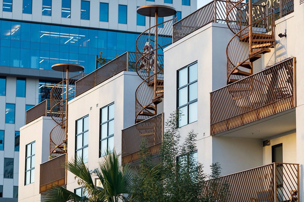 a row of apartments with balconies and fire escapes