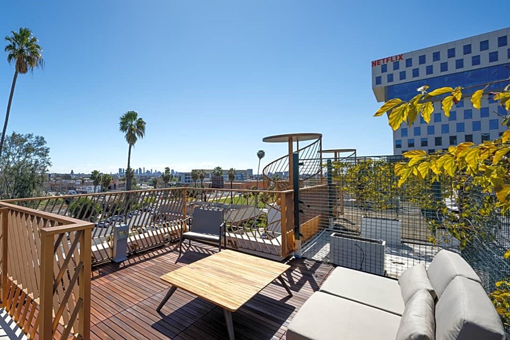 the deck has a view of the city and palm trees