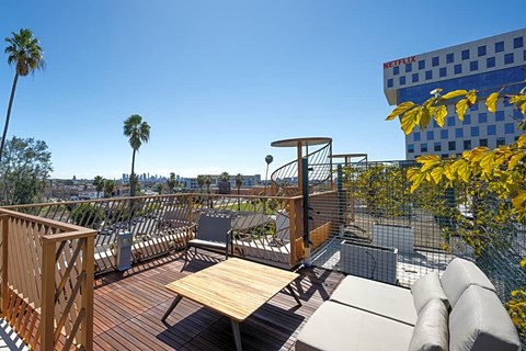the deck has a view of the city and palm trees