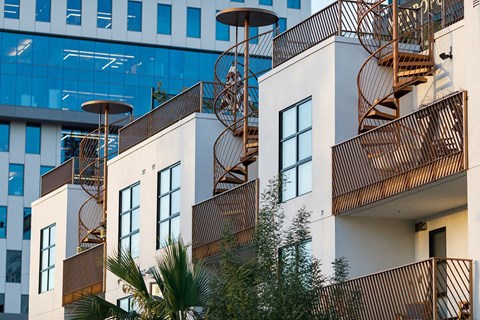 a row of apartments with balconies and fire escapes
