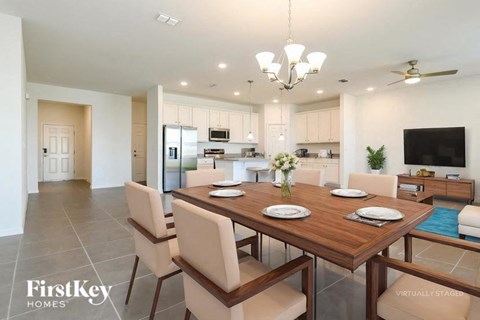 A dining room with a wooden table and chairs.