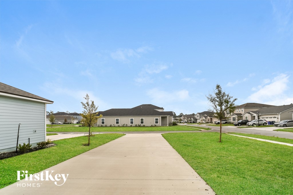 a sidewalk leading to houses in a neighborhood