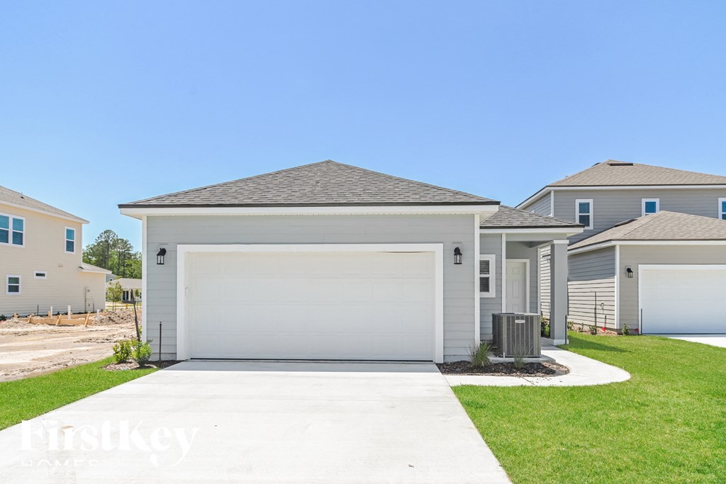 A house with a garage in front of it.