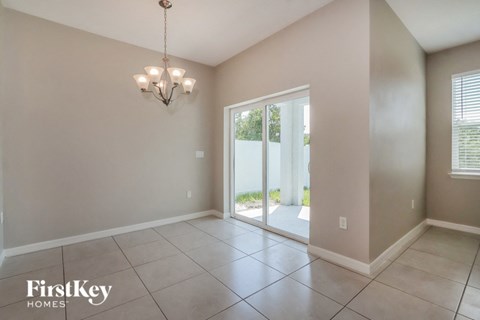 a formal living room with a sliding glass door to a patio