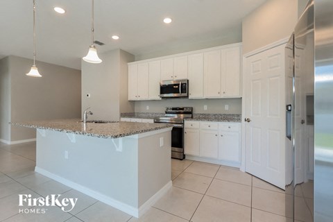 a kitchen with white cabinets and a counter top