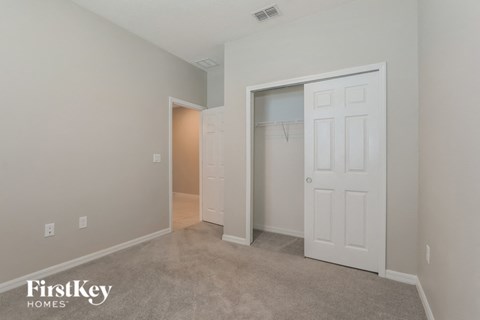 a bedroom with a closet and a door to a closet
