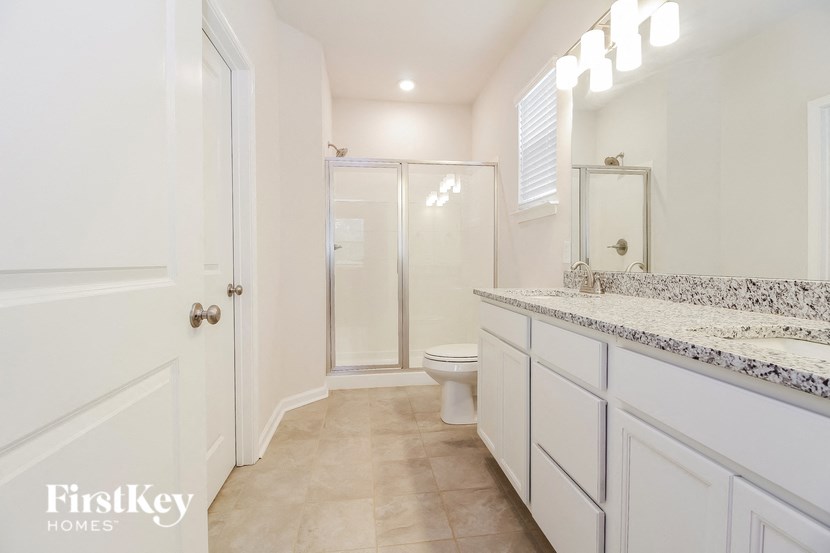 a bathroom with a toilet and a sink and a shower