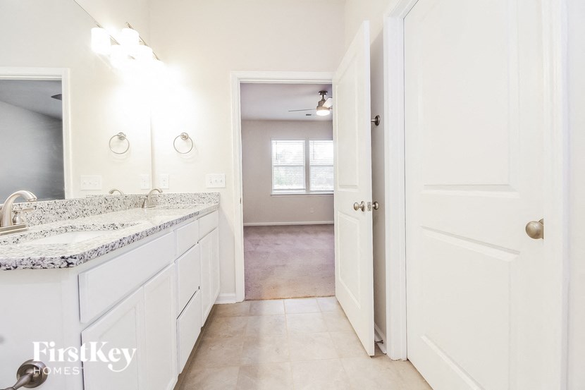 a bathroom with a sink and a door to a hallway