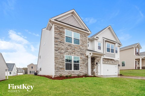 a home with a stone exterior and white siding