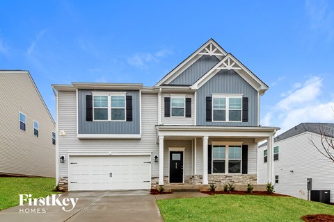 A two-story house with a garage is for sale by FirstKey Homes.