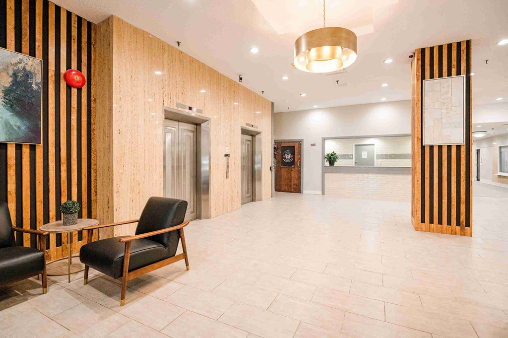 a large lobby with a chair and a table in the center