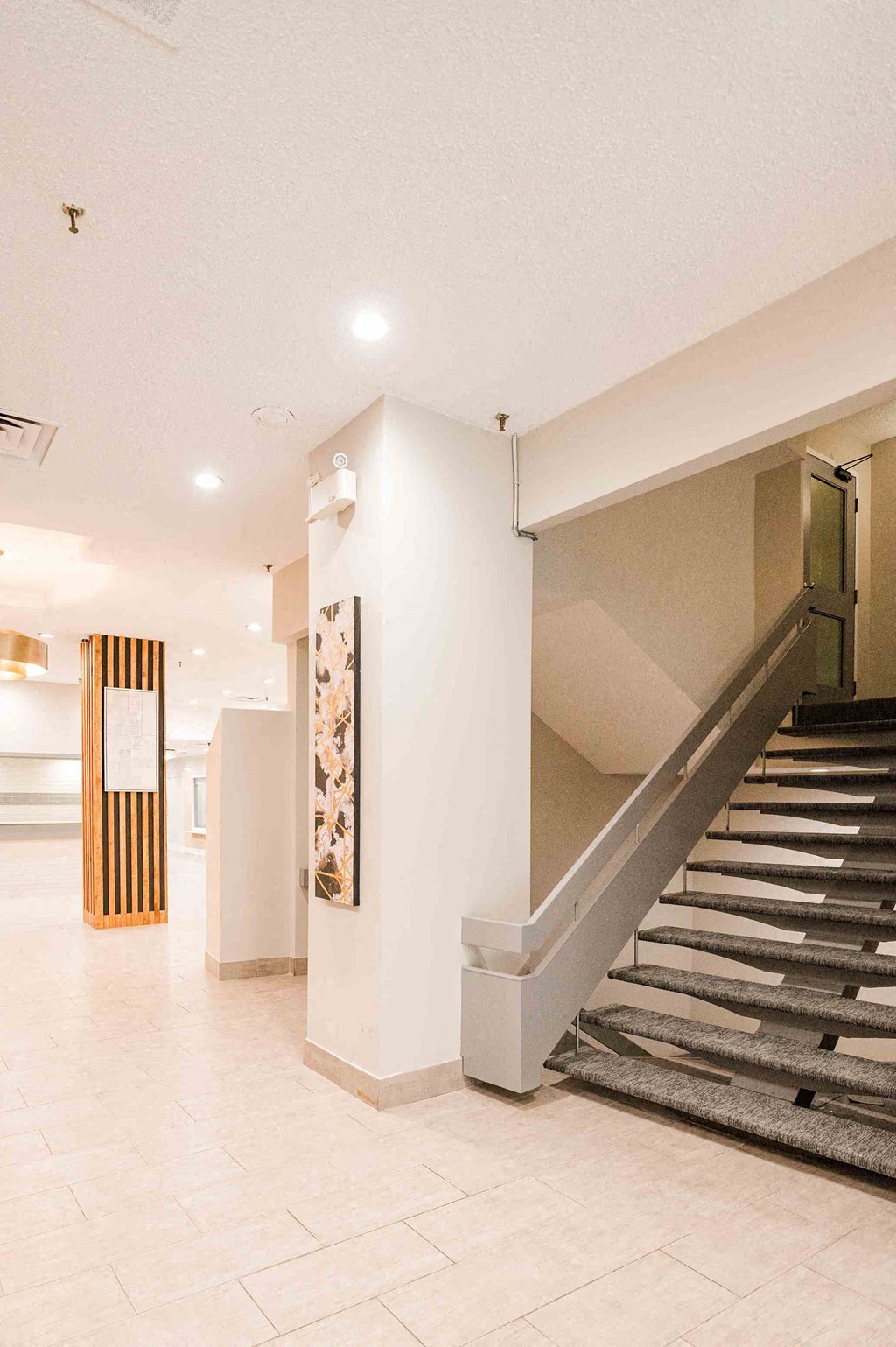 a flight of stairs in a building with a lobby
