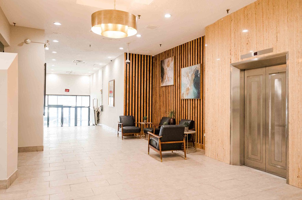 a large lobby with chairs and a reception desk