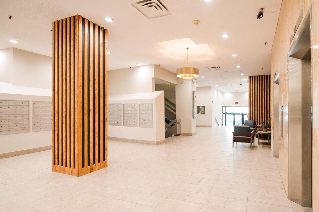 a view of the lobby atrium of a building with a reception desk and chairs