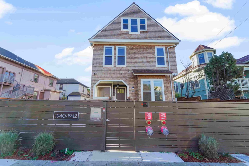 a house with a wooden fence in front of it