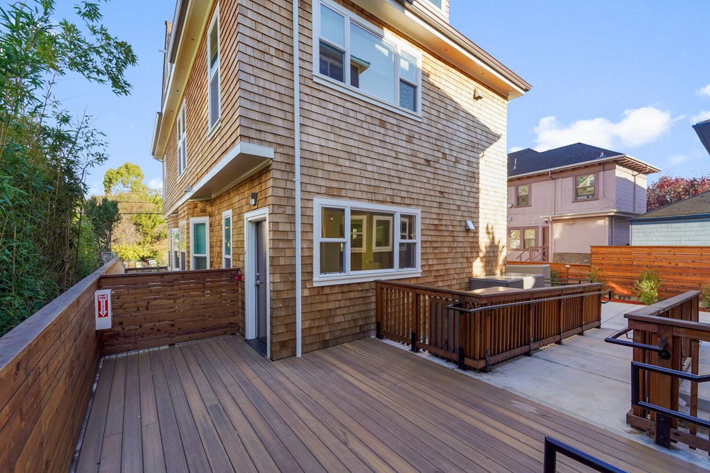 the back of a house with a wooden deck