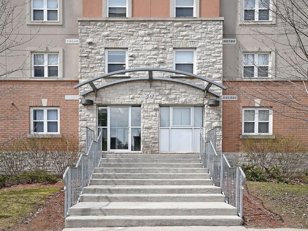 A building with a stone archway entrance and steps leading up to it.