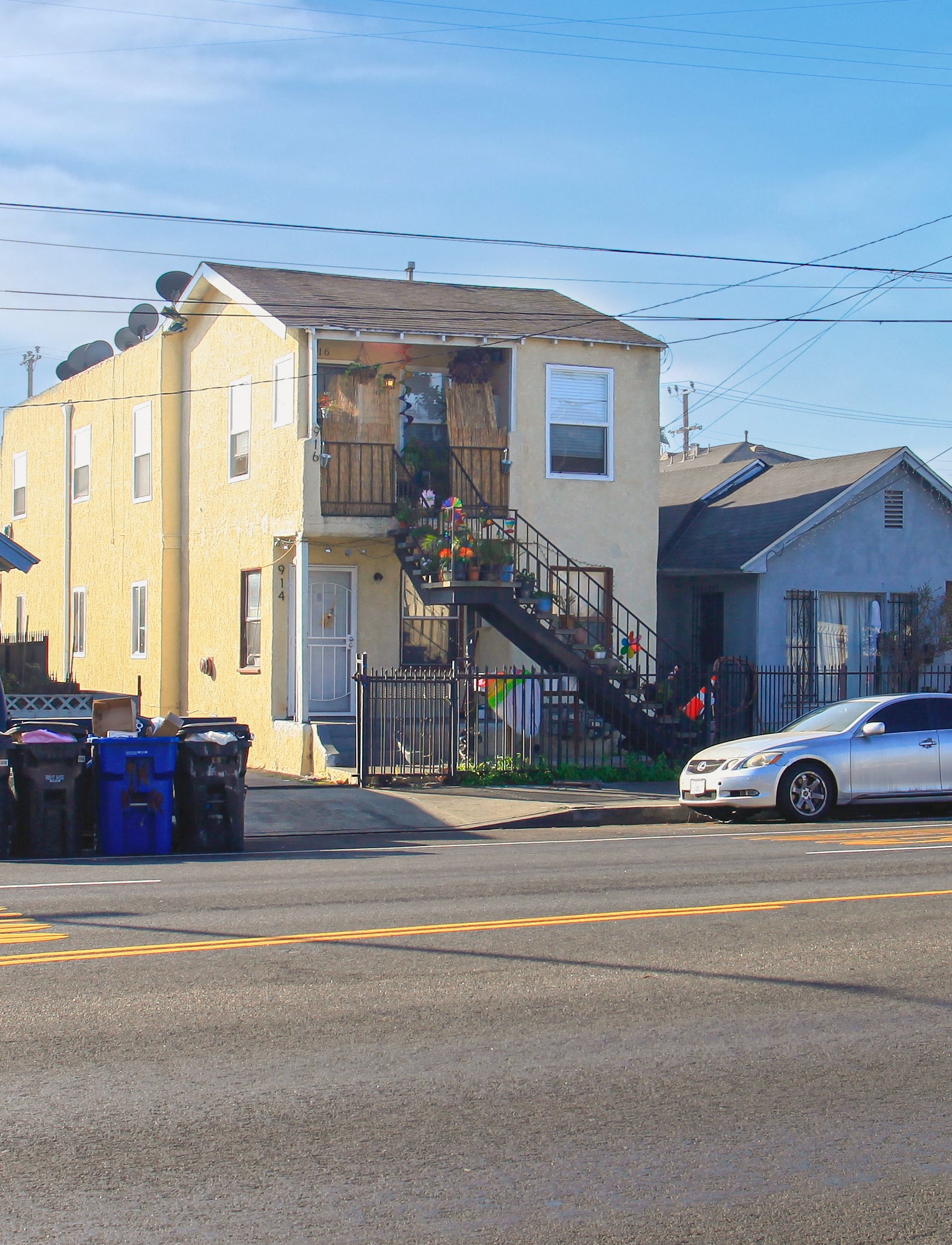 a house on a street with a car parked in front of it