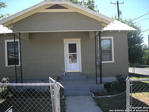 a small house with a porch and a white door