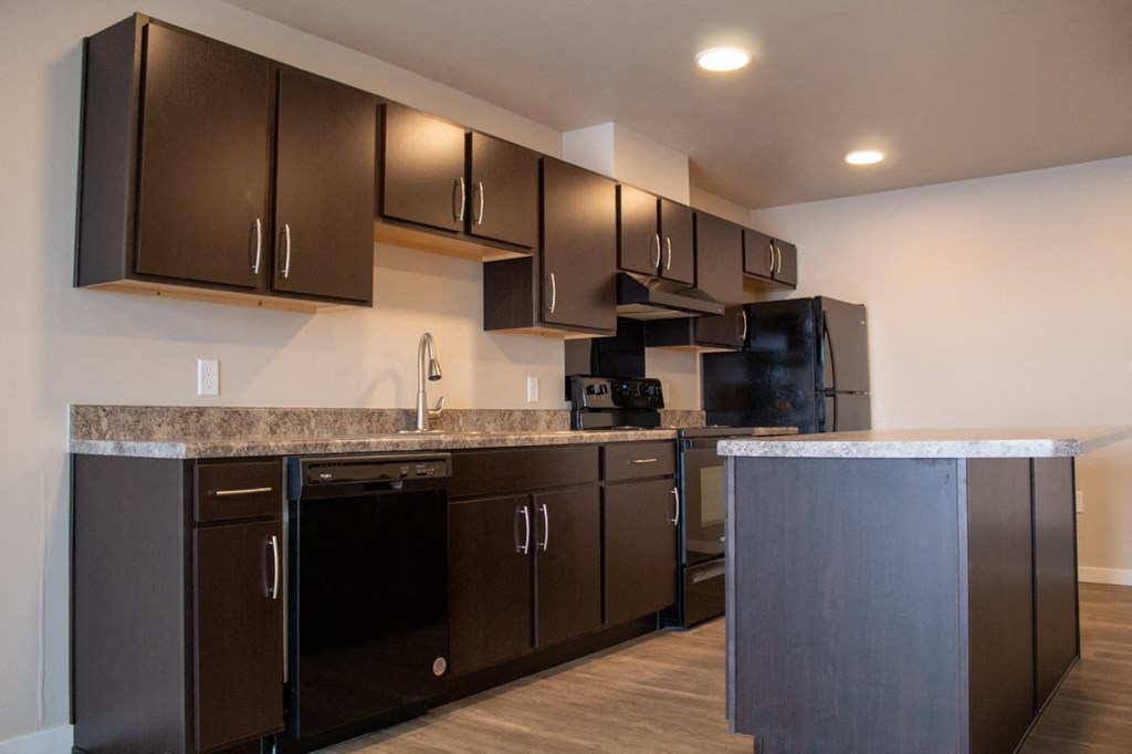 a kitchen with stainless steel appliances and granite counter tops