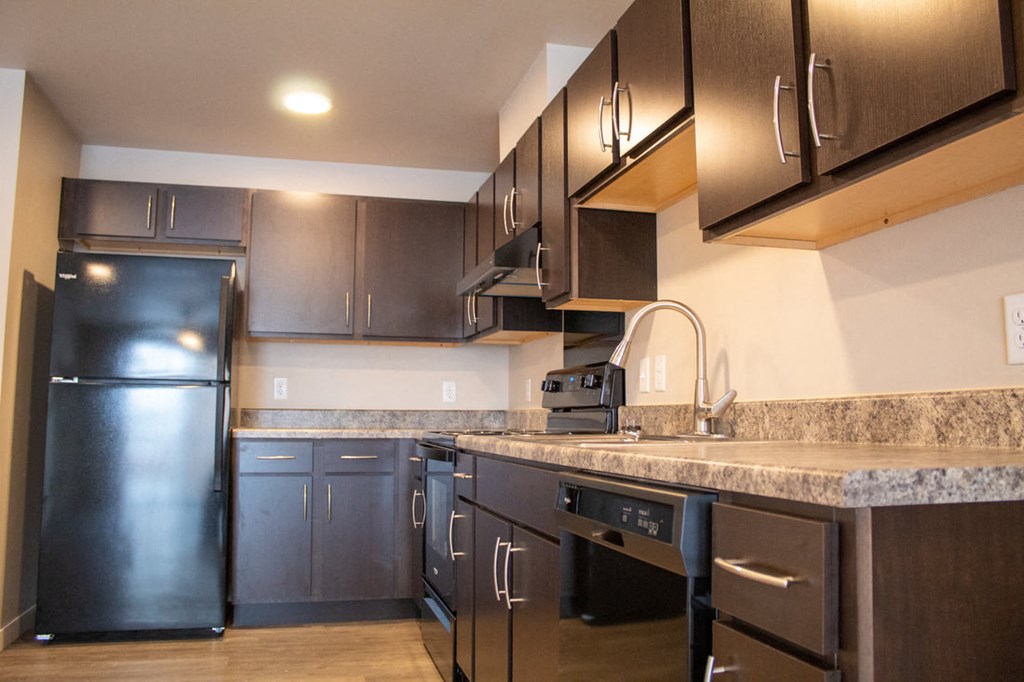 a kitchen with stainless steel appliances and granite counter tops