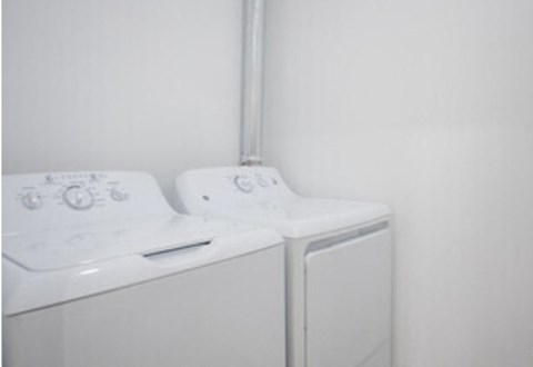 a white washer and dryer in a white room