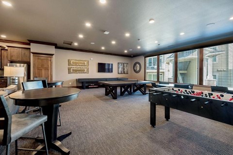 a game room with a foosball table and ping pong table