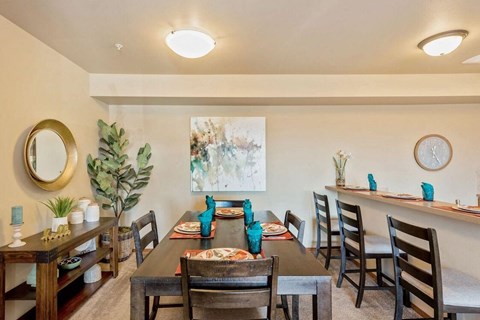a dining room with a long table and chairs