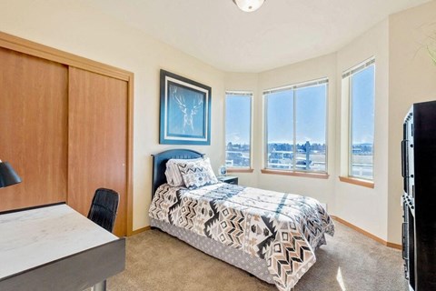 a bedroom with a bed and four windows