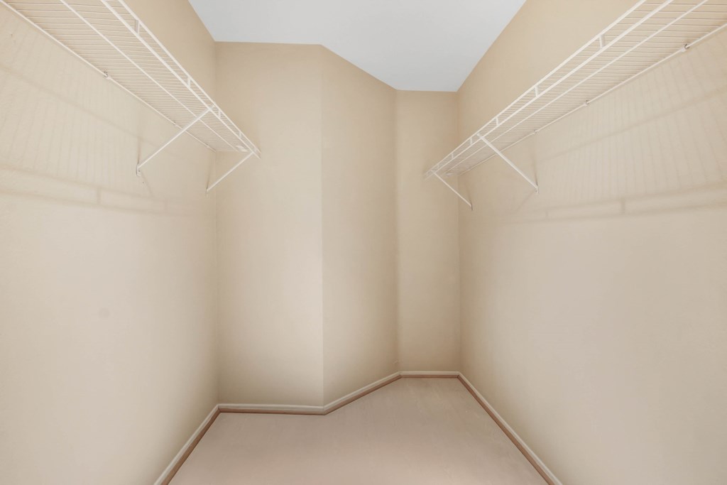 A room with beige walls and a white ceiling with a skylight.