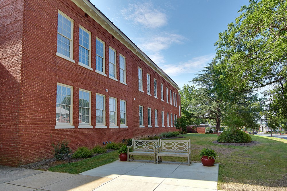a bench in front of a brick building