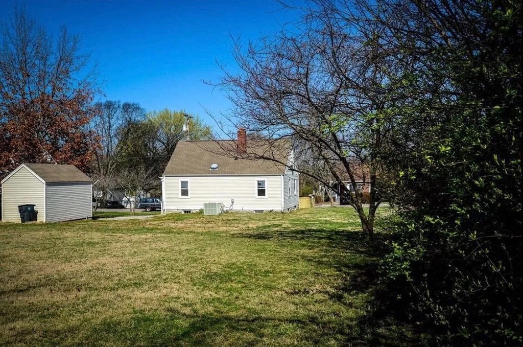 a white house with a yard and a tree