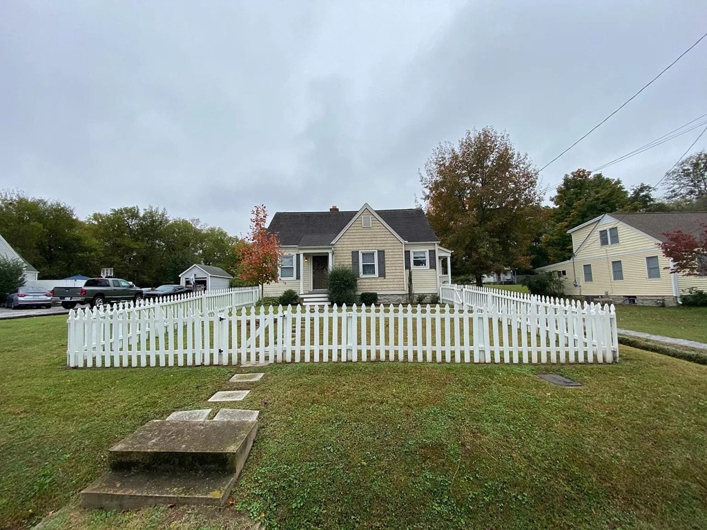 a white picket fence in front of a house