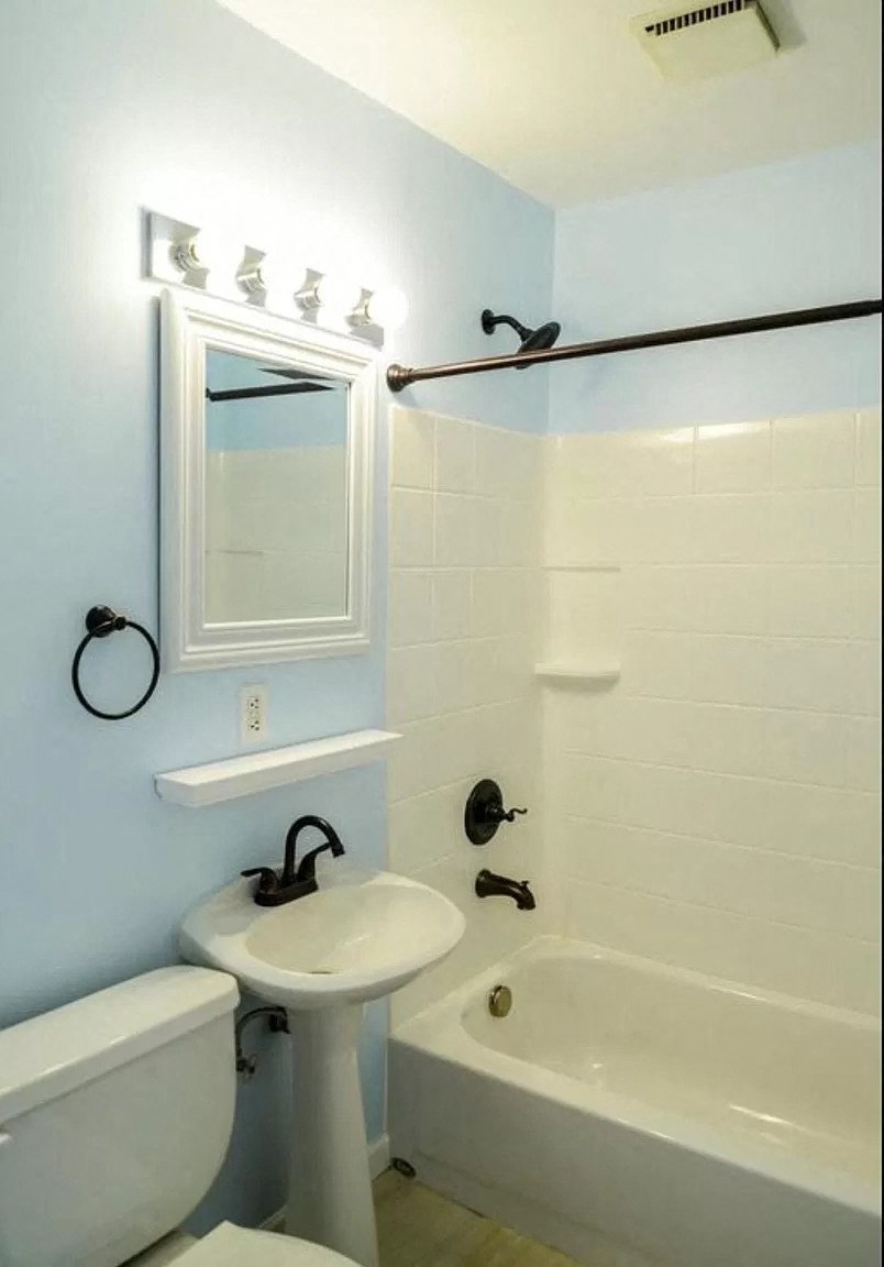 a bathroom with a sink toilet and a bath tub