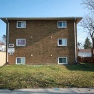 a brick house with windows on the side of it