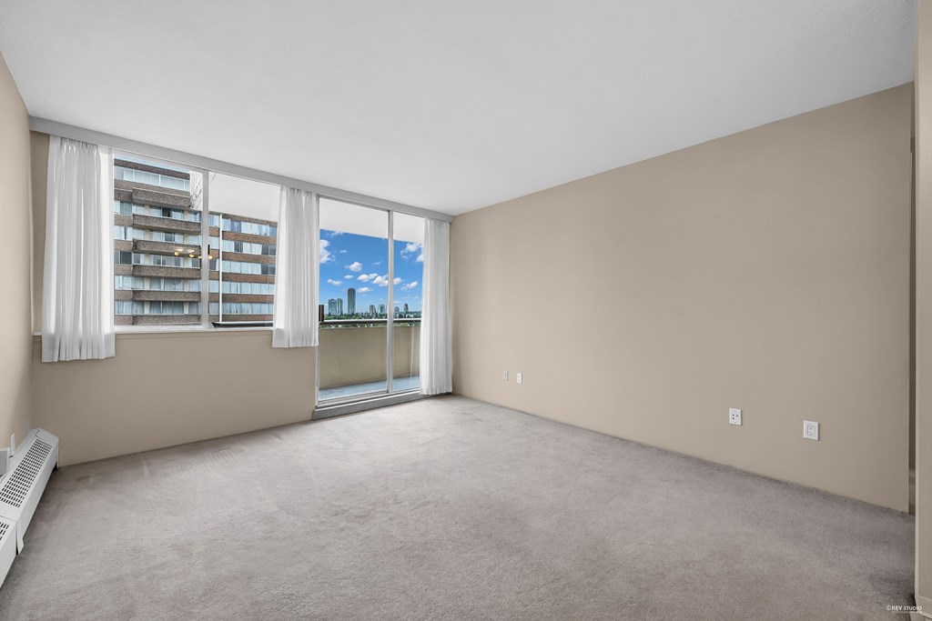 A room with a window overlooking a cityscape.