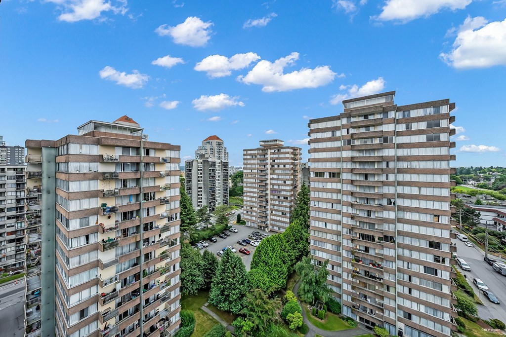 A view of a residential area with multiple apartment buildings and a clear blue sky.