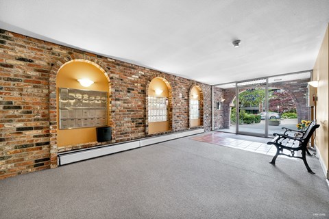 A room with brick walls and a bench.