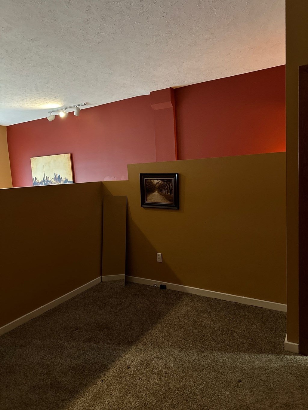 a room with a red and yellow wall and a white ceiling