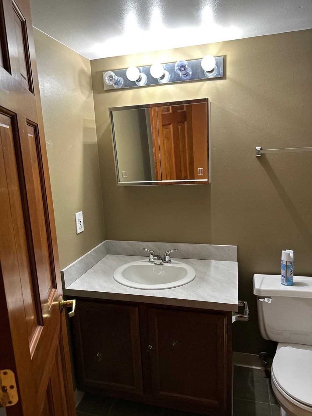 a small bathroom with a sink and a mirror