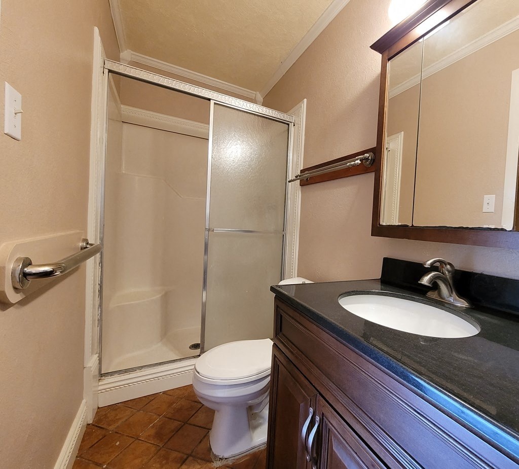 a bathroom with a sink toilet and shower