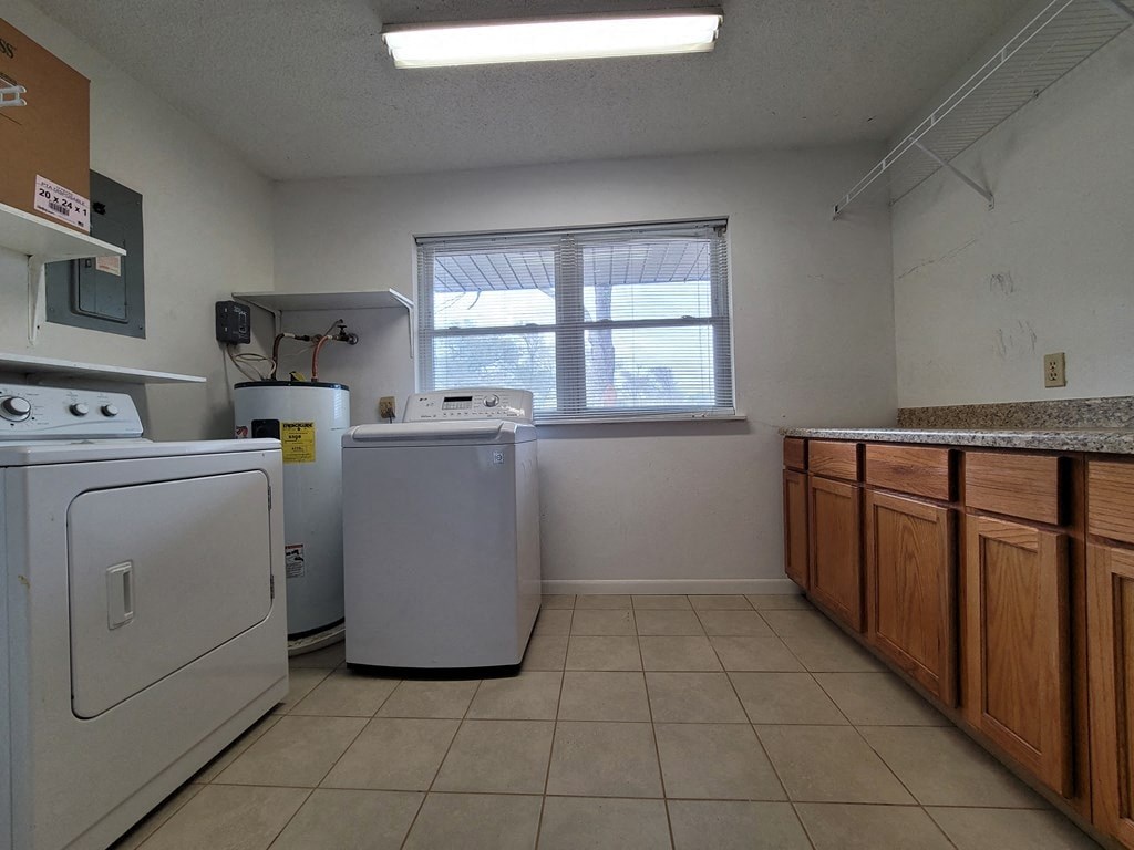 a kitchen with two washing machines and a window